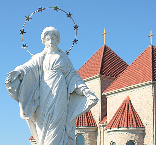 stone statue of Mother Mary in front of the Carmelite Monastery