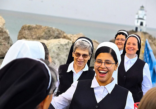 a smiling group of Franciscan Sisters of Christian Charity on the lake shore in Manitowoc Wisconsin
