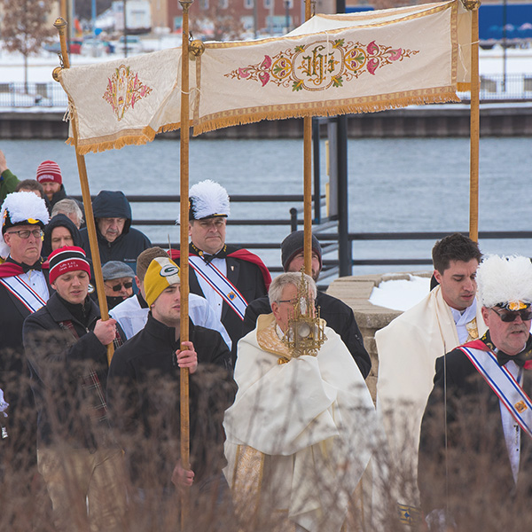 a Catholic procession outside led by Bishop Ricken